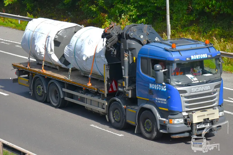 Stainless steel tanks secured on a Nortons flatbed lorry