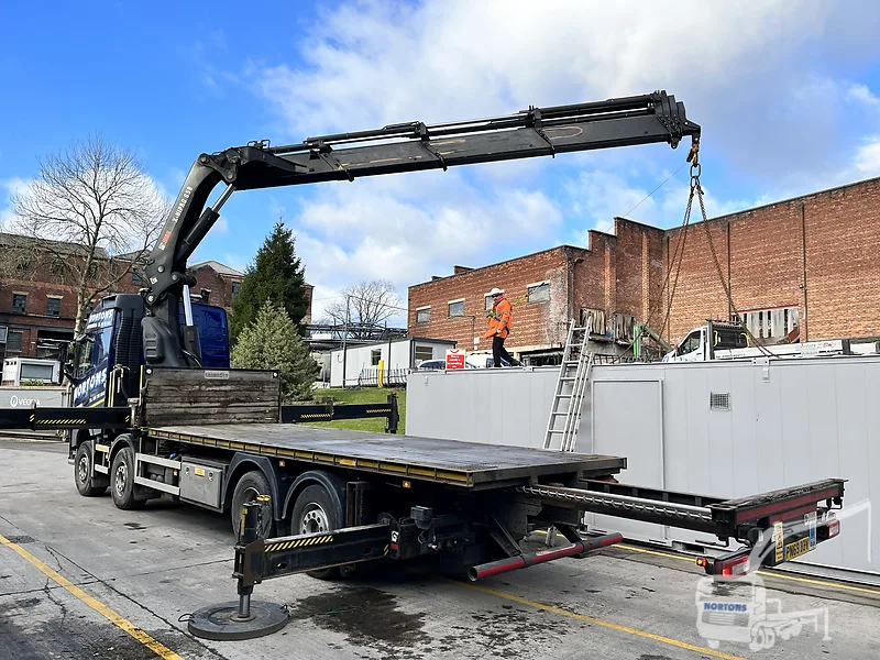 Hiab flatbed lorry delivering a cabin to a Bristol site