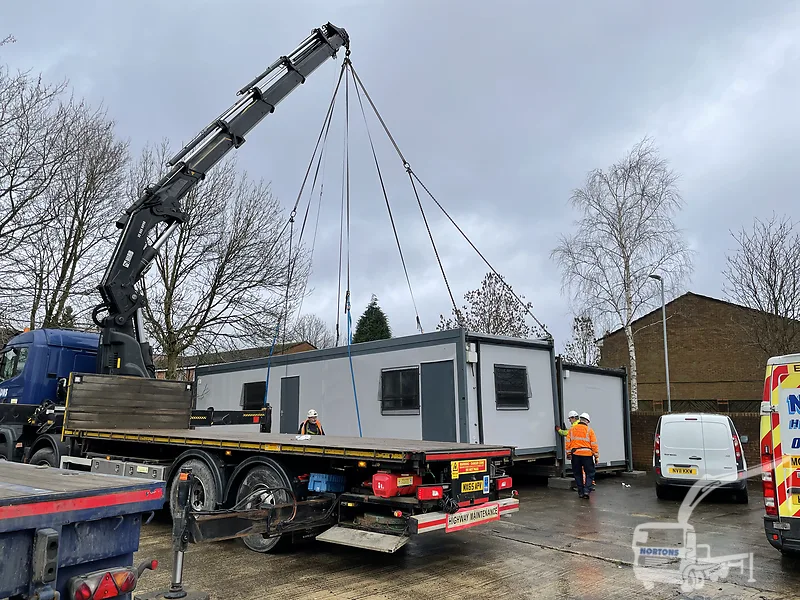 Hiab lorry operator delivering a cabin on a Birmingham site