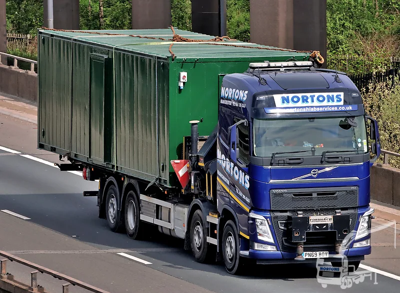 Hiab lorry hauling a cabin on the motorway — hiab hire Leeds and West Yorkshire