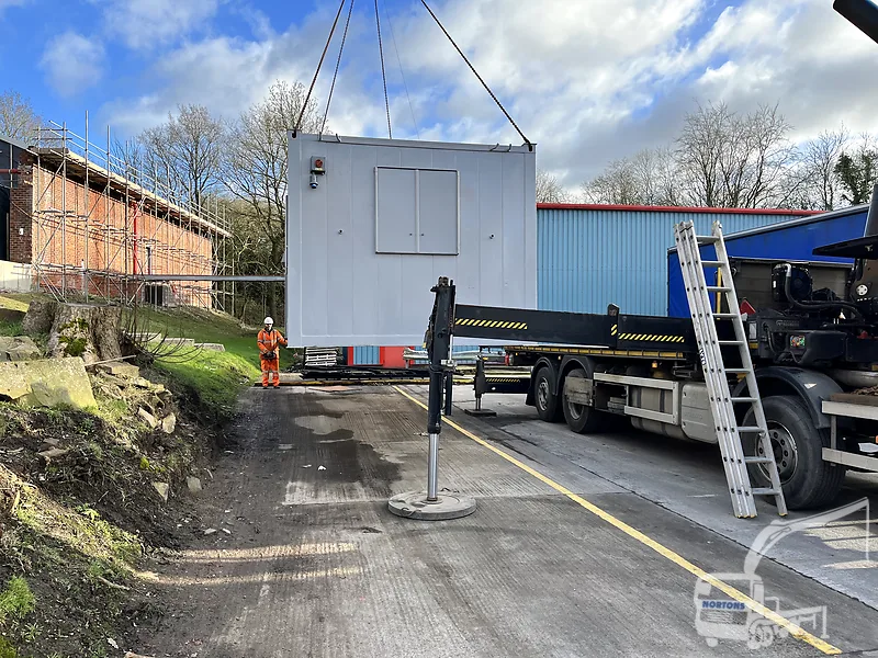 Hiab lorry lifting a cabin into a site compound near Newcastle