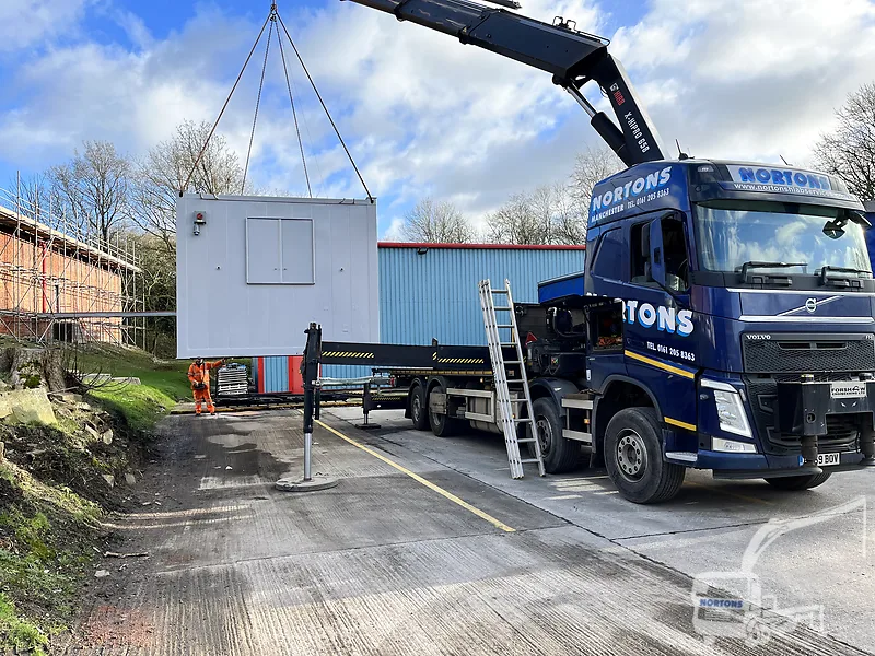 Hiab lorry placing a portable cabin on a Warrington site
