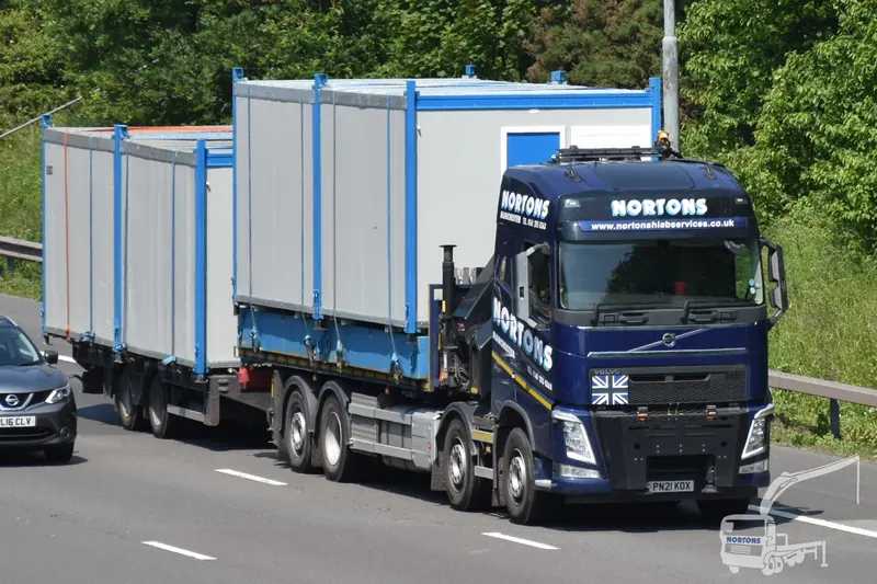 Hiab hire Warrington - hiab lorry carrying cabins along the M6 near Warrington