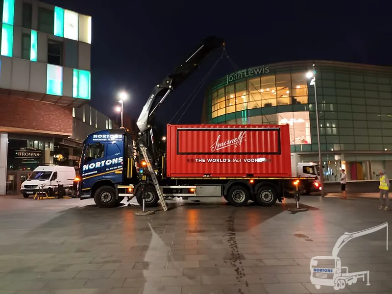 Hiab crane lorry lifting a container at night — hiab hire Liverpool and Merseyside