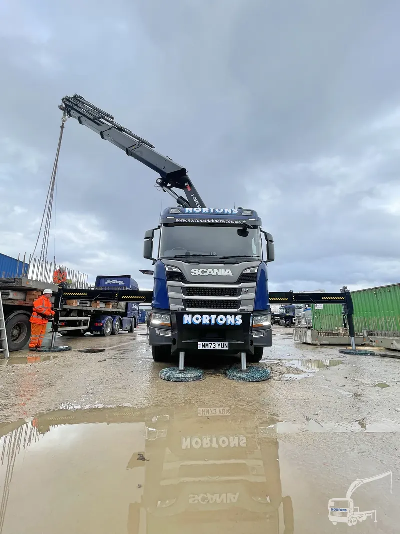 Lorry loader crane extended during depot lifting operations