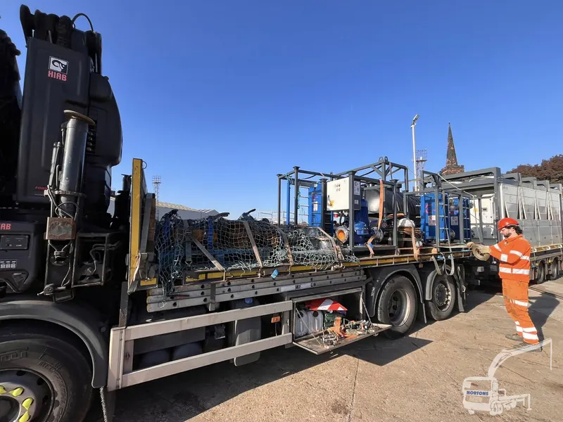 Driver and crew delivering glazed frames with a lorry loader