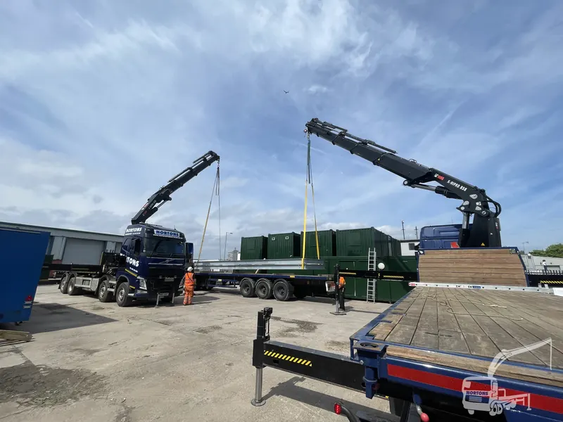 Generator sets craned from a trailer by hiab