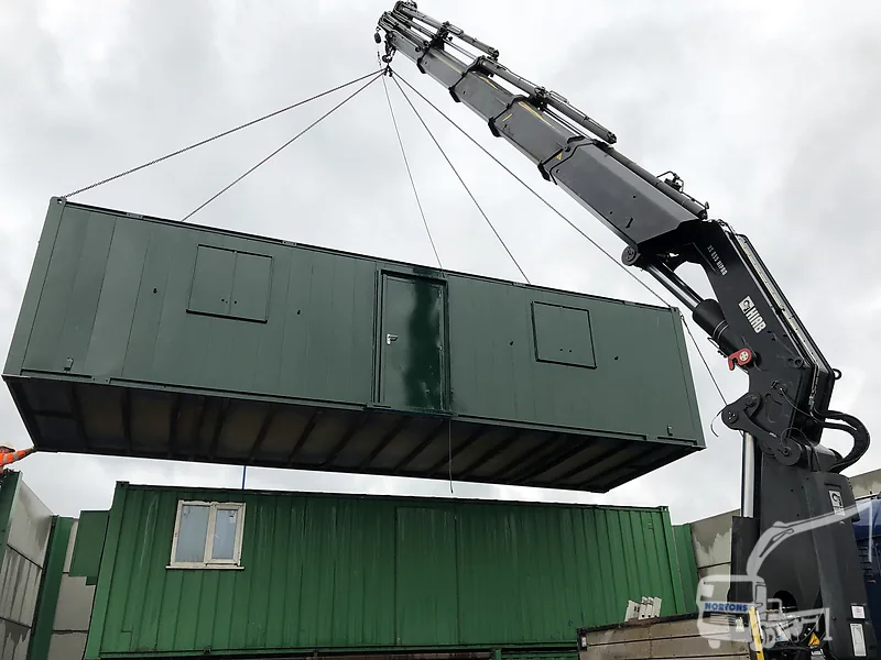 Hiab container delivery - hiab lorry lifting a large shipping container into place