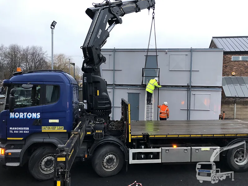 Hiab lorry lifting modular building panels on a Nottingham site