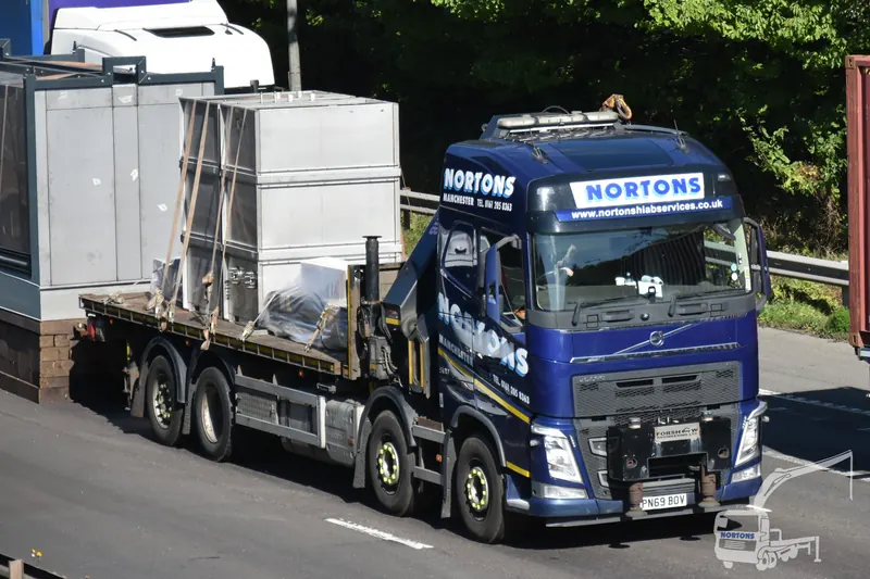Hiab lorry transporting a portable cabin on the UK motorway network