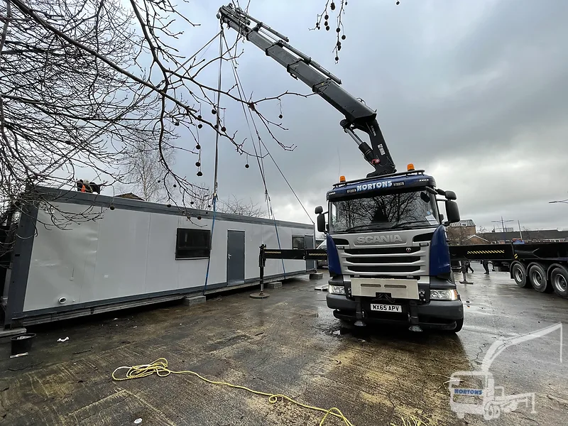 Hiab lorry placing modular building units at a Manchester school site