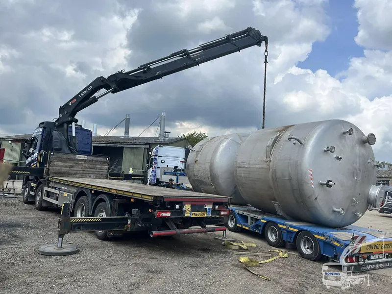 Large steel tank secured for haulage on a hiab truck