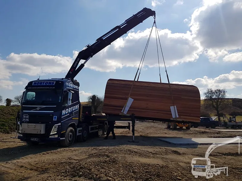 Hiab truck loaded with a timber cabin — operated hiab hire UK