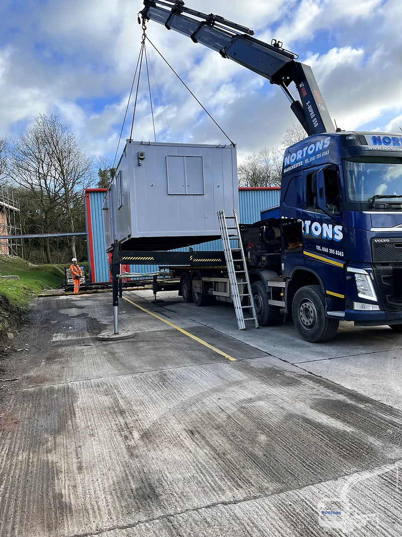 Nortons Hiab Services lorry delivering a cabin on a UK street