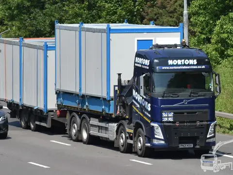 Portable cabins heading north on the M6 behind a hiab lorry