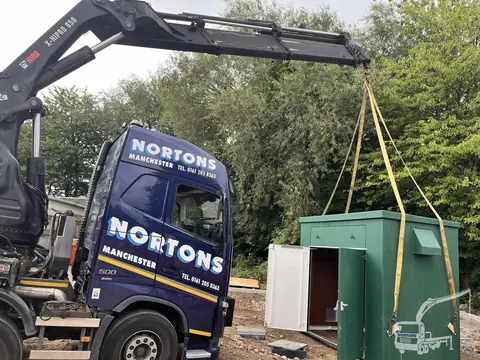 Hiab lifting a kiosk unit over site fencing